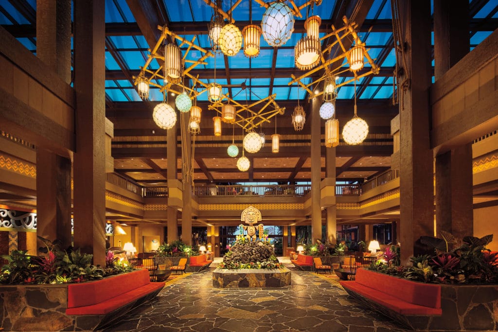 Red fabrics, wooden pillars, gold edging and eclectic lights adorn the beautiful lobby of Walt Disney World's Polynesian Village Resort