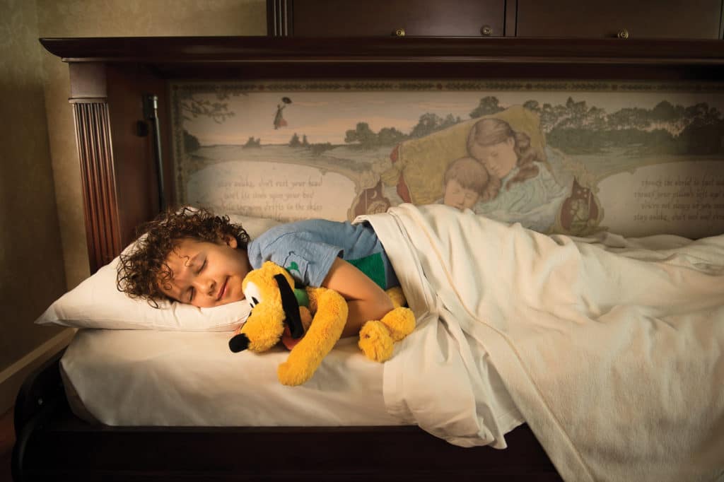 This adorable little kid sleeps with a smile on his face and a stuffed Pluto in his arms, safe in the knowledge that he's having the time of his life vacationing at Walt Disney World and staying at the amazing Grand Floridian Resort and Spa