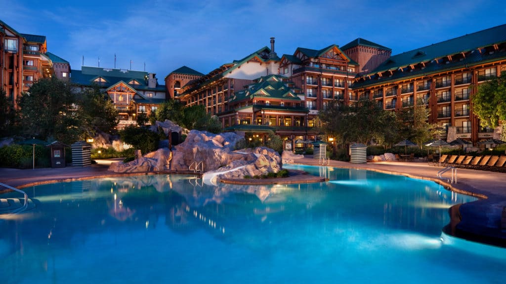 The breathtaking pool at Walt Disney World's Wilderness Lodge has boulders, blue clear waters, and bedazzling views to relax in.