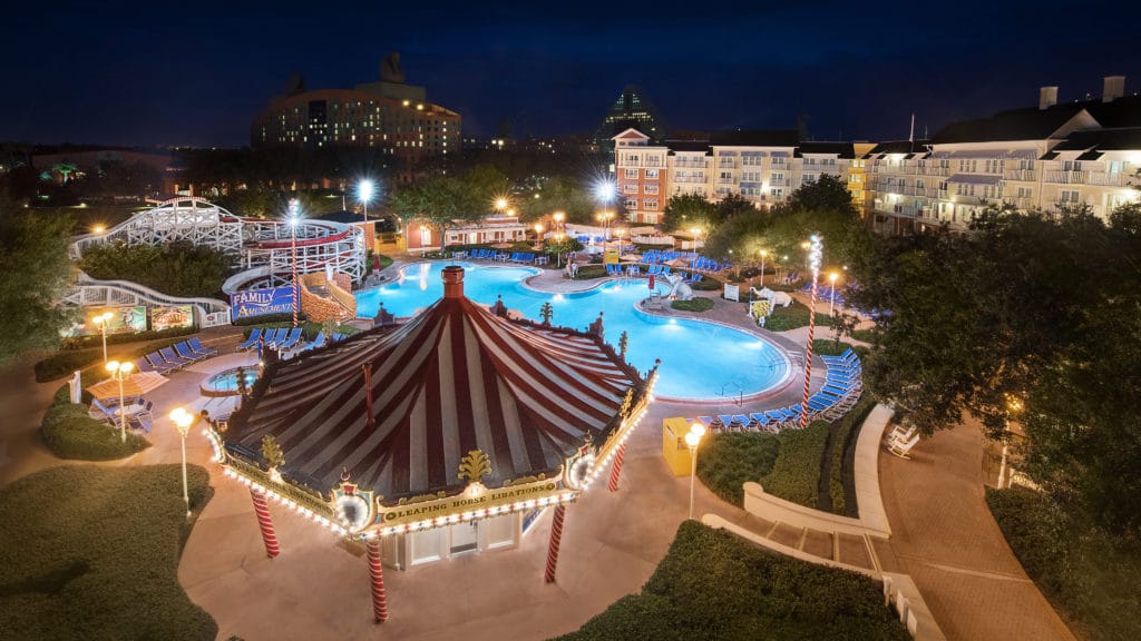 Twinkle lights, a carousel snack shop, and a rollercoaster behind the pool provide the carnival feeling for Walt Disney World's BoardWalk Inn.