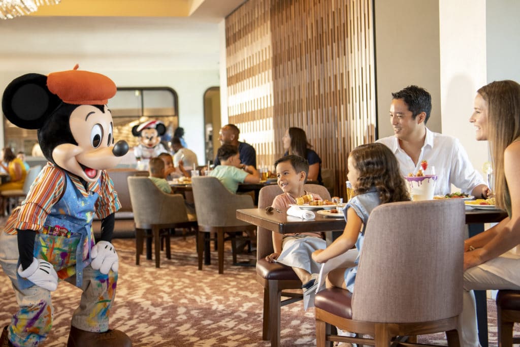Riviera Resort has a lot to offer, like dining with the painting costumed Mickey Mouse as this family of four is clearly enjoying.