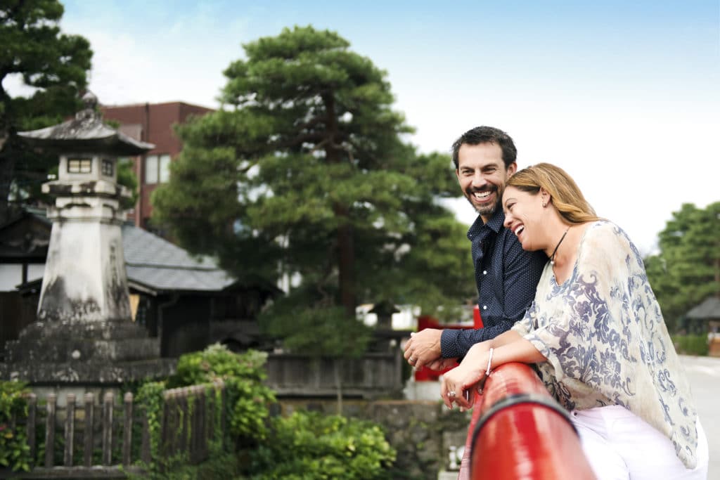 Adventures By Disney outdid themselves, providing an amazing view of Kamakura, Japan for this happily laughing couple, the woman in her light summer outfit tilting toward her man who gazes joyfully into the camera.