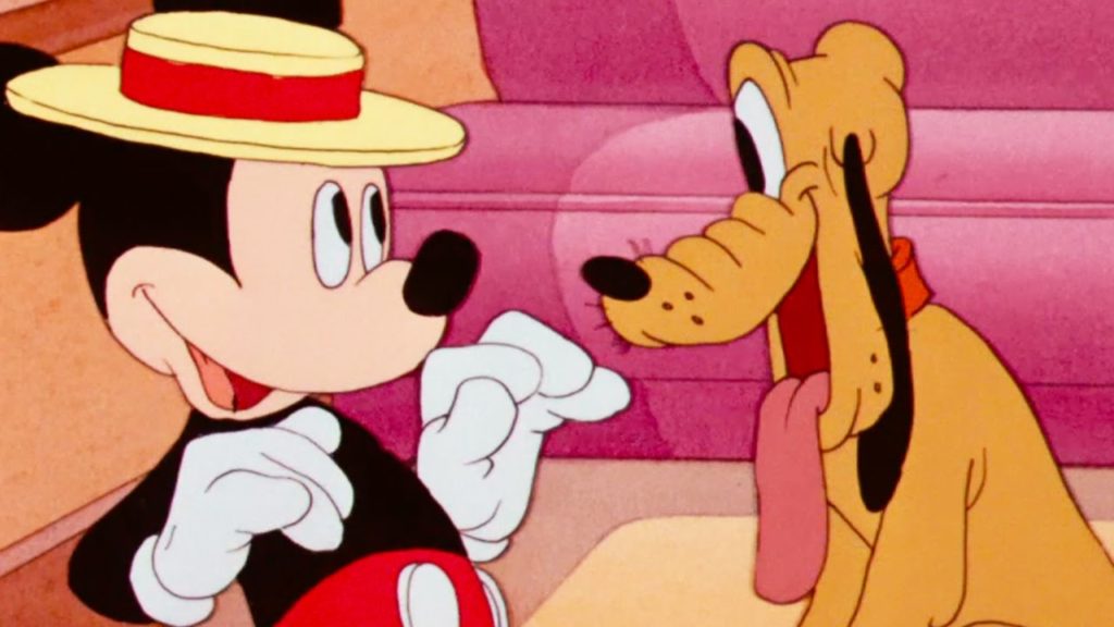 If you stay at one of the best hotels near Disneyland for families, you can even bring your dog along - just as Mickey Mouse would insist, as evidenced by how much he loves his dog Pluto in this adorable cartoon still with Mickey on the left (sporting a straw hat with red ribbon) with a huge grin on his face, about to hug an equally smiling Pluto on the left with his tongue joyfully hanging out.