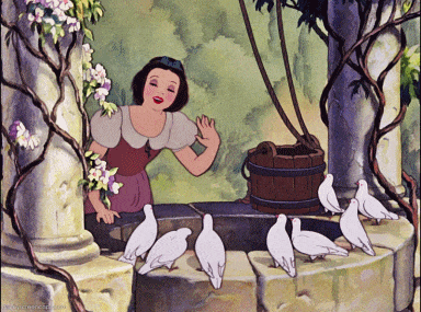 A still from the original Disney "Snow White" movie, where - similar to the statue at Disneyland, CA - sings into her vine-wrapped wishing well, surrounded by the singing birds she has befriended.