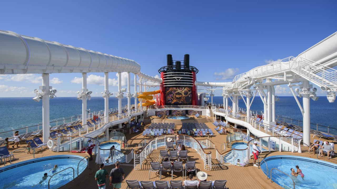 One of the favorite Disney ships, the Disney Wish, has fabulous dockside pools and an above deck water coaster pictured here out on the wide open ocean