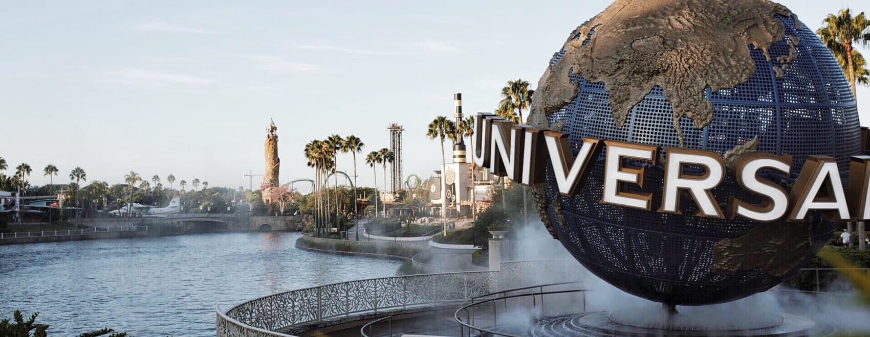 A beautiful sunny day at the entrance to Universal Studios Orlando, overlooking the water and the Universal sign in fun Florida.