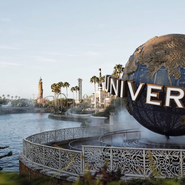A beautiful sunny day at the entrance to Universal Studios Orlando, overlooking the water and the Universal sign in fun Florida.