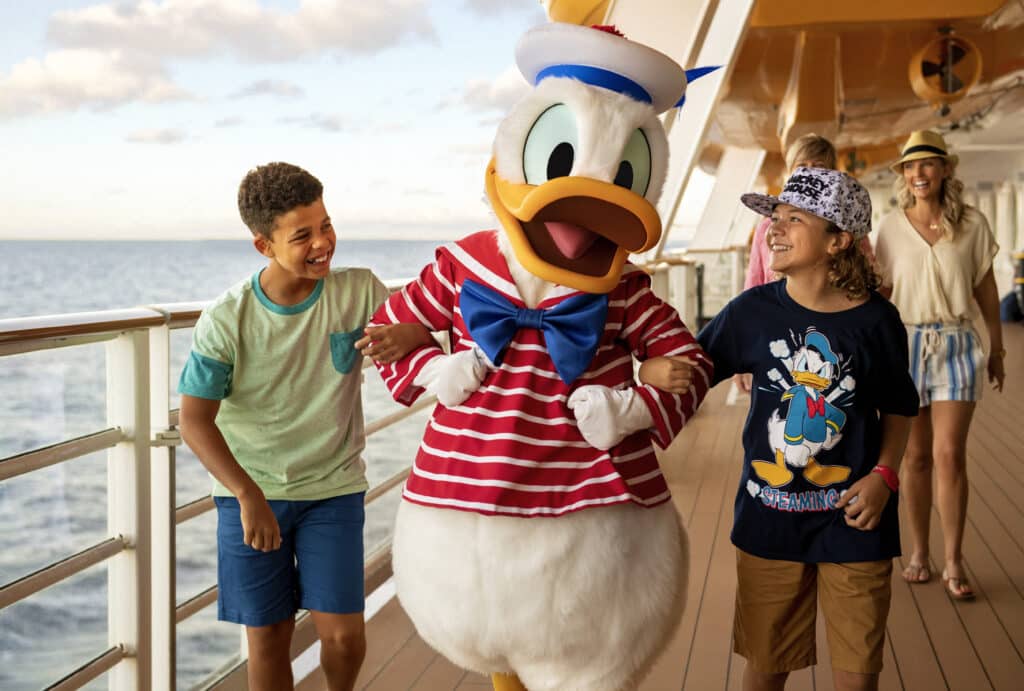 Donald Duck and some new friends on the Disney Dream enjoying the current Disney Discounts for 2023 European Cruises